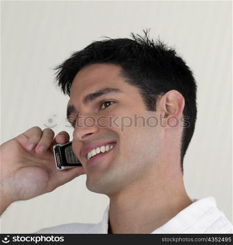 Side profile of a young man talking on a mobile phone