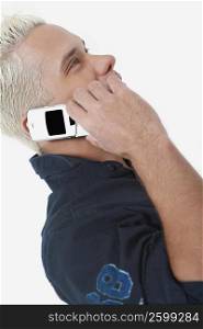 Side profile of a young man using a mobile phone