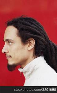 Side profile of a young man with dreadlocks