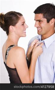 Side profile of a young woman and a mid adult man smiling