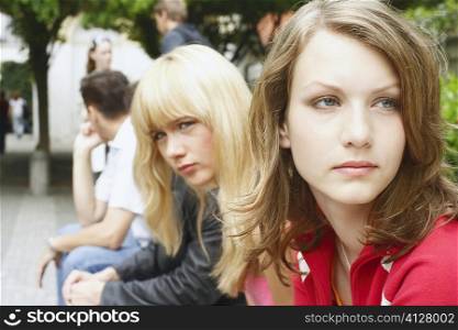 Side profile of a young woman and a teenage girl sitting