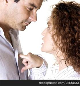 Side profile of a young woman arguing with a mid adult man