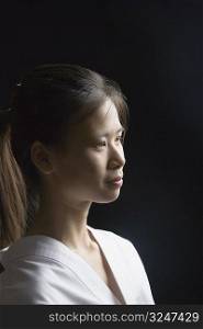 Side profile of a young woman contemplating
