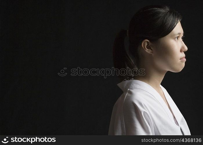 Side profile of a young woman contemplating