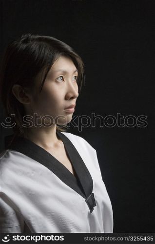 Side profile of a young woman contemplating in gi