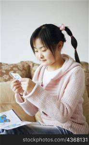 Side profile of a young woman doing embroidery