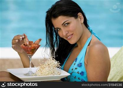 Side profile of a young woman having a meal