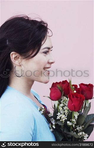 Side profile of a young woman holding a bouquet of flowers