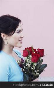 Side profile of a young woman holding a bouquet of flowers