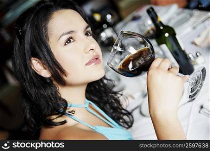 Side profile of a young woman holding a glass of wine