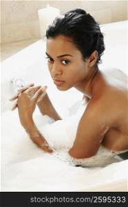 Side profile of a young woman in a bathtub