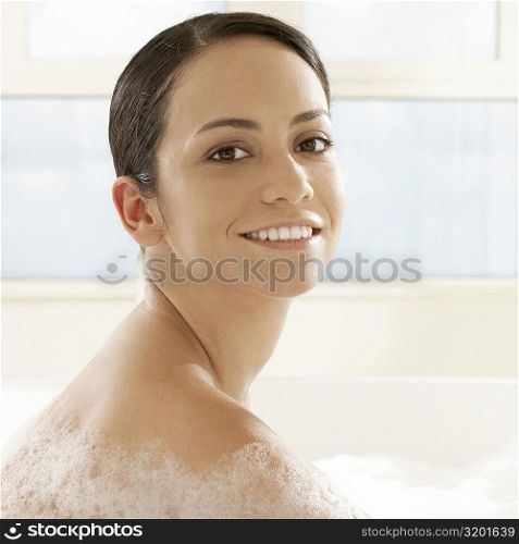 Side profile of a young woman in a bubble bath
