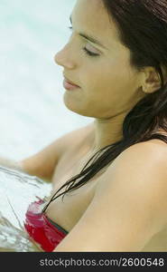 Side profile of a young woman in water