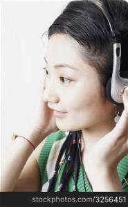 Side profile of a young woman listening to music