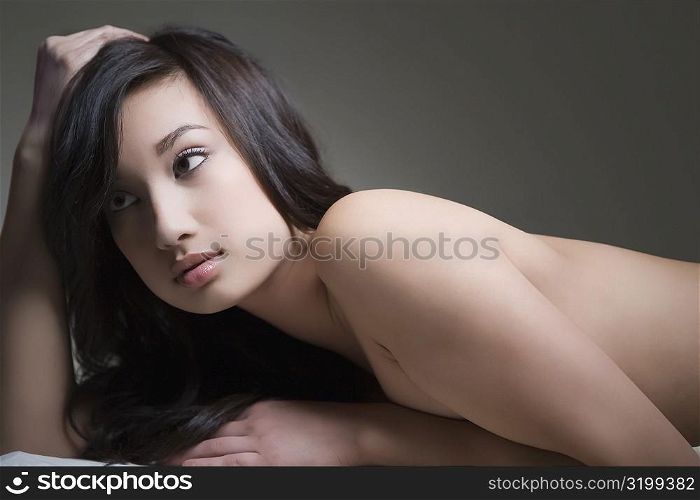 Side profile of a young woman lying on a massage table