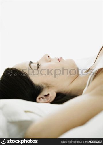 Side profile of a young woman lying on her back