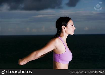 Side profile of a young woman meditating