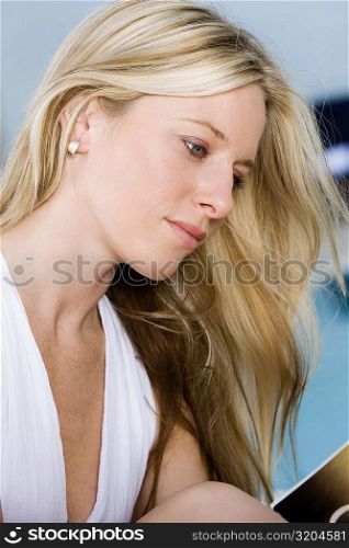Side profile of a young woman reading a book
