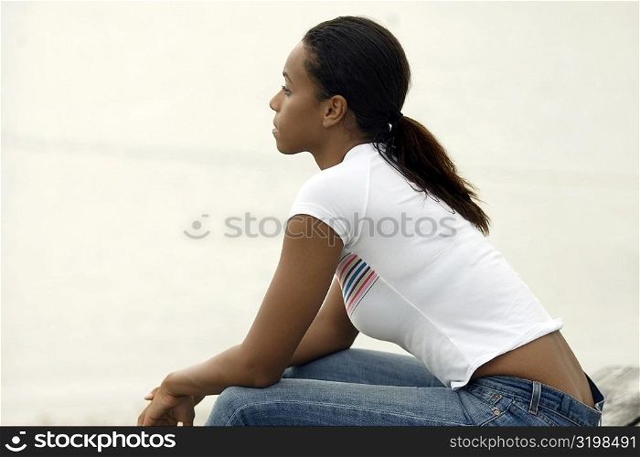 Side profile of a young woman sitting