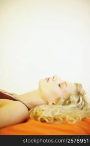 Side profile of a young woman sleeping on the bed