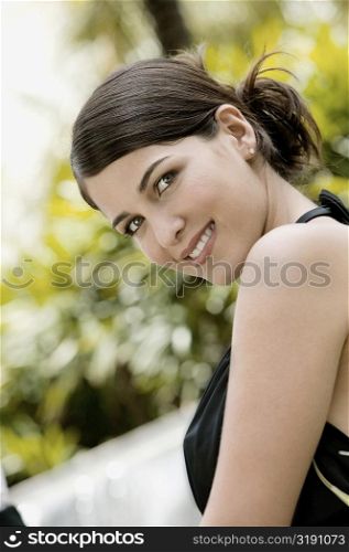 Side profile of a young woman smiling
