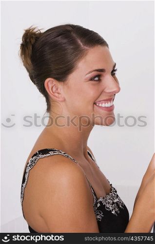 Side profile of a young woman smiling