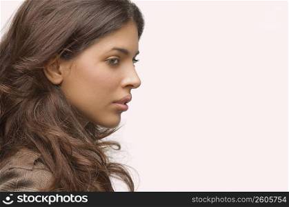 Side profile of a young woman thinking