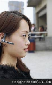 Side profile of a young woman wearing a hands free device