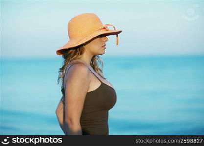 Side profile of a young woman wearing a hat