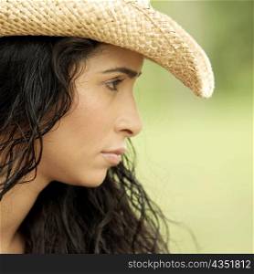 Side profile of a young woman wearing a hat