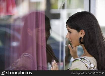 Side profile of a young woman window shopping