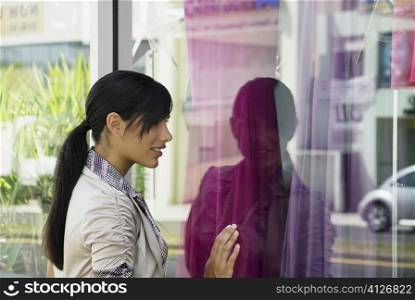 Side profile of a young woman window shopping