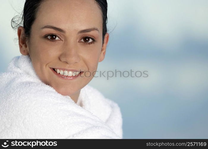 Side profile of a young woman wrapped in a towel