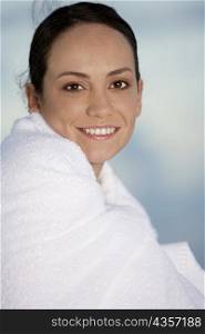 Side profile of a young woman wrapped in a towel
