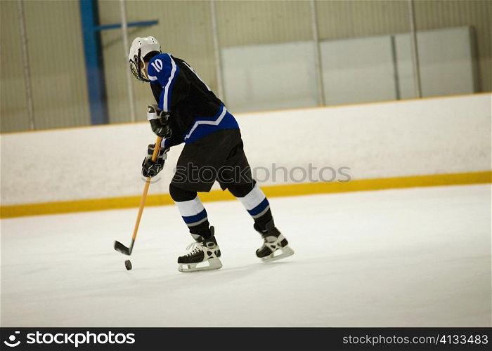 Side profile of an ice hockey player playing ice hockey