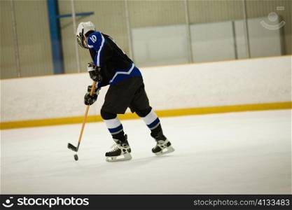 Side profile of an ice hockey player playing ice hockey