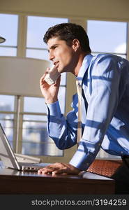 Side profile of businessman talking on a cordless phone