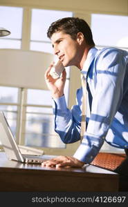 Side profile of businessman talking on a cordless phone