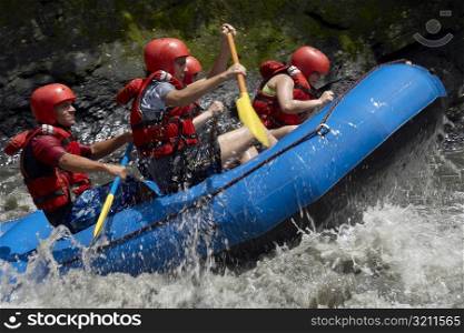 Side profile of five people rafting in a river