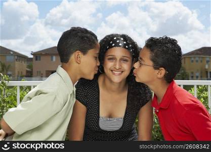 Side profile of two boys kissing a teenage girl