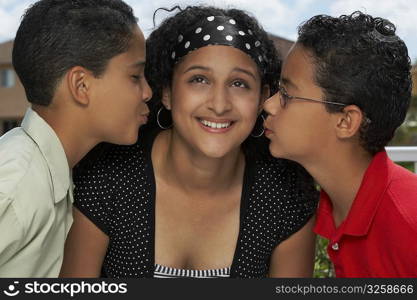 Side profile of two boys kissing a teenage girl