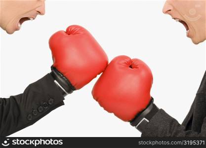 Side profile of two businessmen boxing