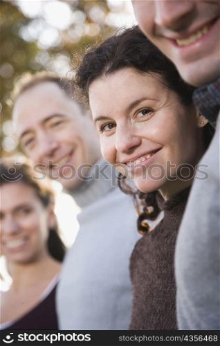 Side profile of two couples standing together and smiling