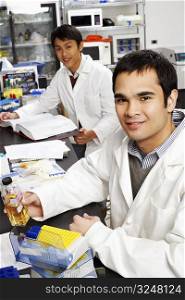 Side profile of two male pharmacists in a laboratory