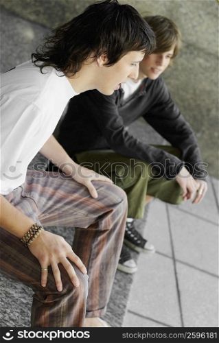 Side profile of two teenage boys sitting together