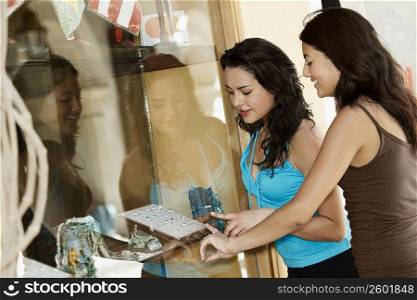 Side profile of two young women selecting rings in a jewelry store