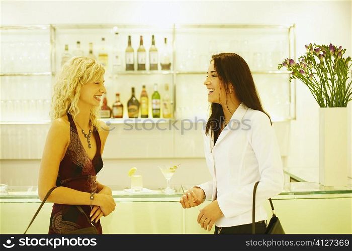 Side profile of two young women talking