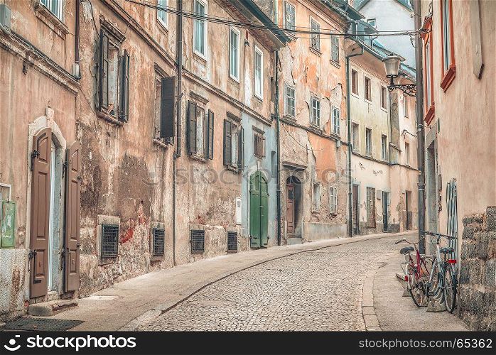 Side street with old, shabby buildings, yet colorful, located in the old city center of Ljubljana, the capital of Slovenia.