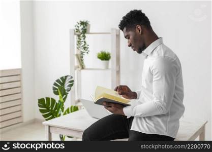 side view african american man reading