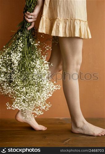side view alluring woman posing while holding bouquet spring flowers